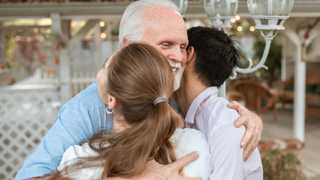 grandpa hugging grandchildren