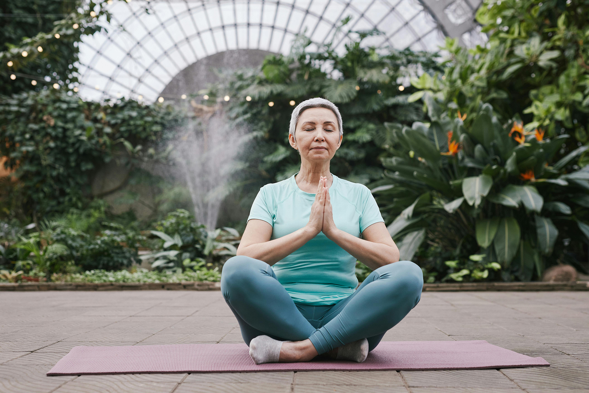 woman meditating on yoga mat