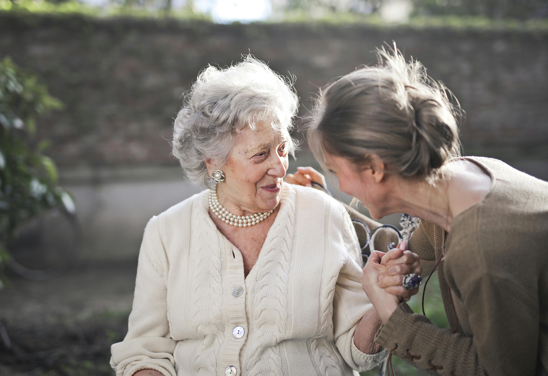 woman assisting elderly parent