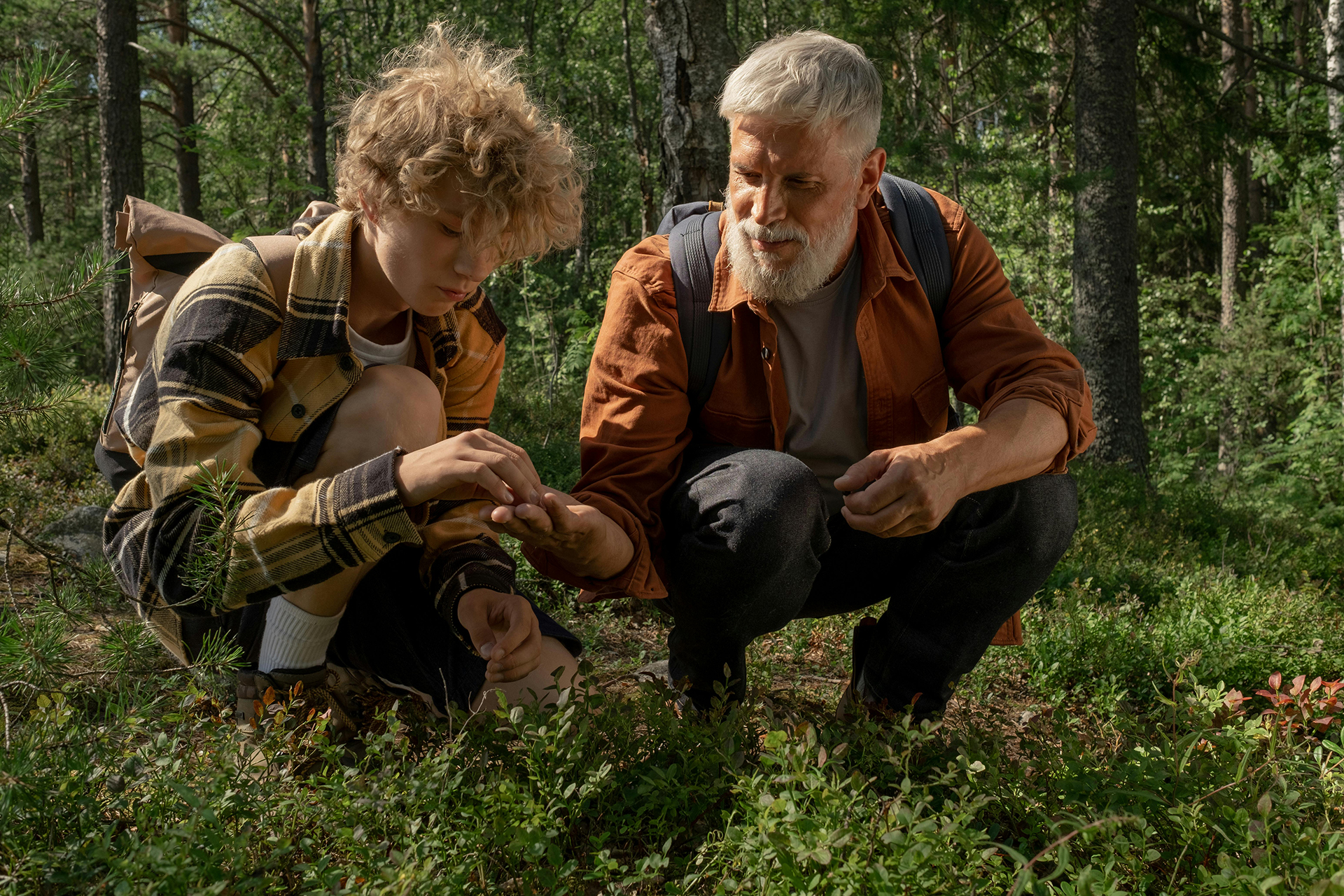 grandfather hiking in woods with grandson